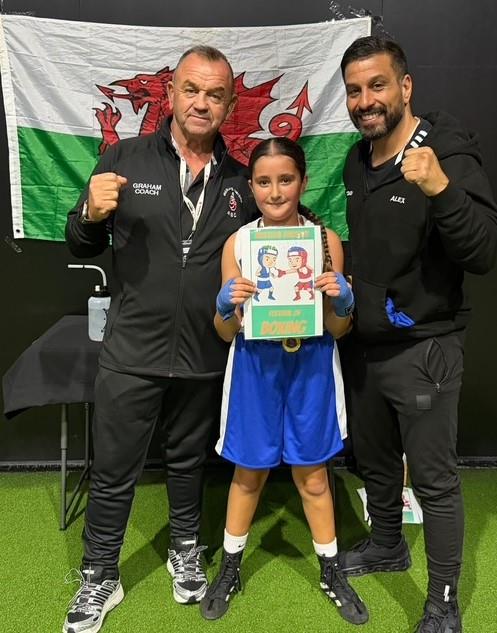 Amirah McGeown with coaches Graham Brockway and Alex Ward after her first venture into the ring